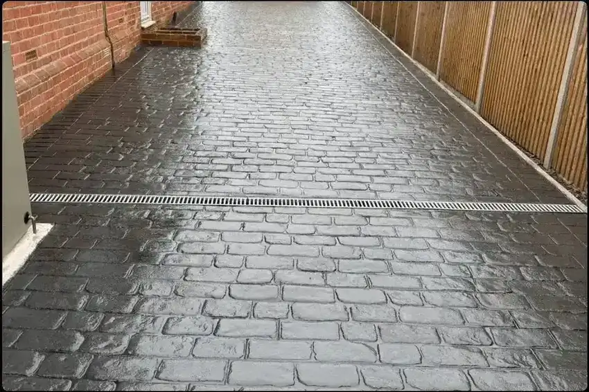 Grey block paving with planted border